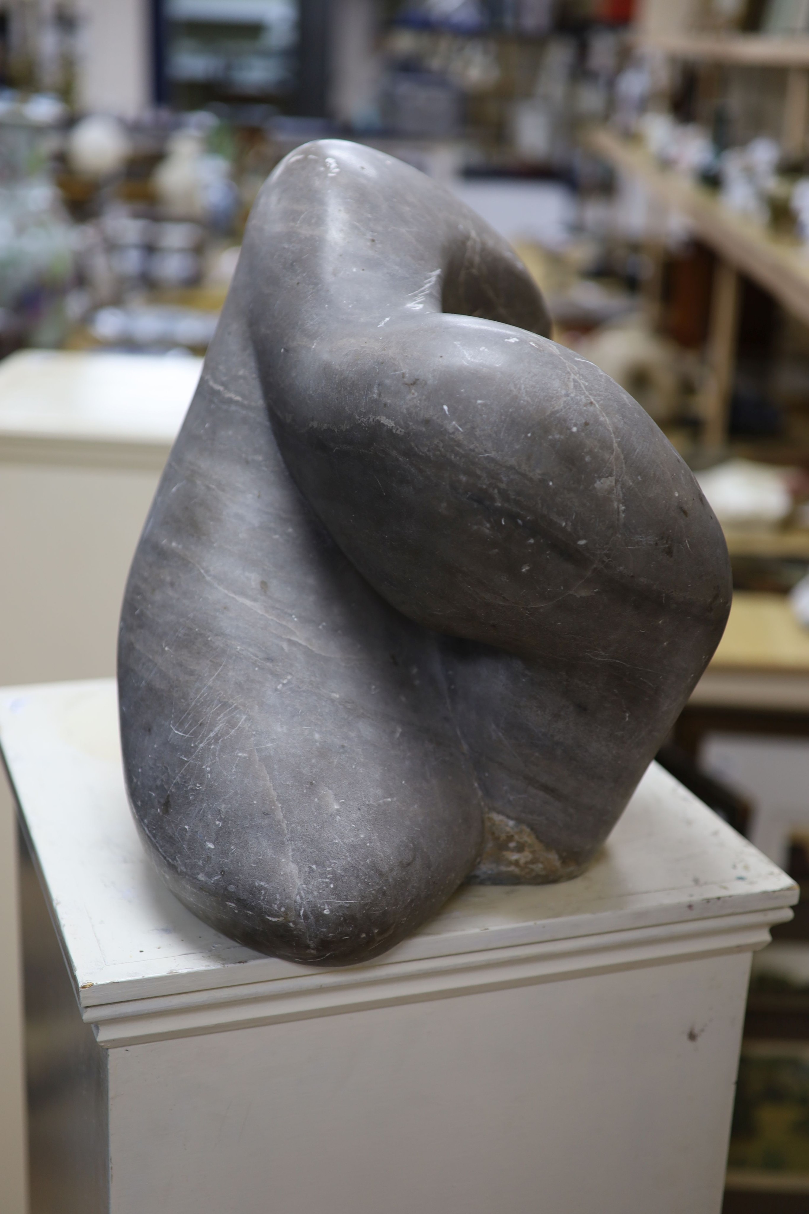 Wilby Hart, grey marble sculpture, abstract form, W 46cm. H 35cm. on a painted wood pedestal.